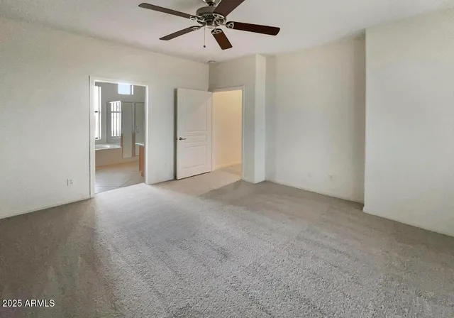 a view of an empty room with a fan