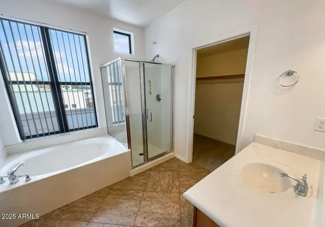a bathroom with a tub and shower