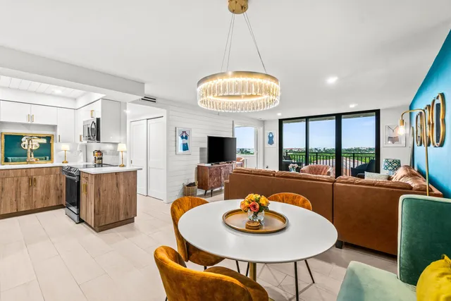 a view of a dining room with furniture a livingroom and chandelier
