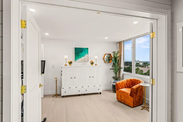 a view of a balcony with potted plants and palm trees