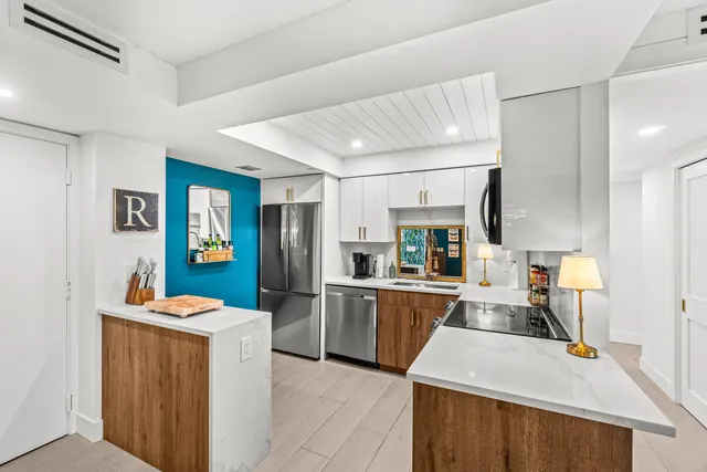 a large kitchen with kitchen island a sink stainless steel appliances and cabinets