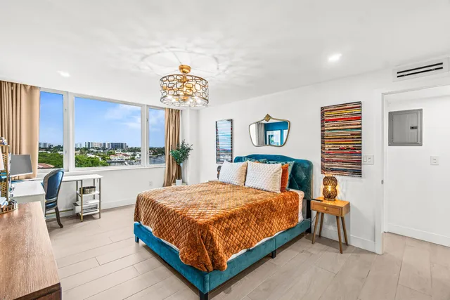 a bedroom with a bed and a chandelier