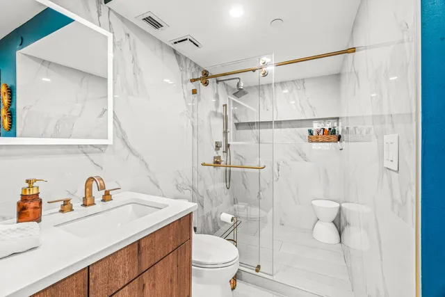 a bathroom with a sink a mirror and a shower