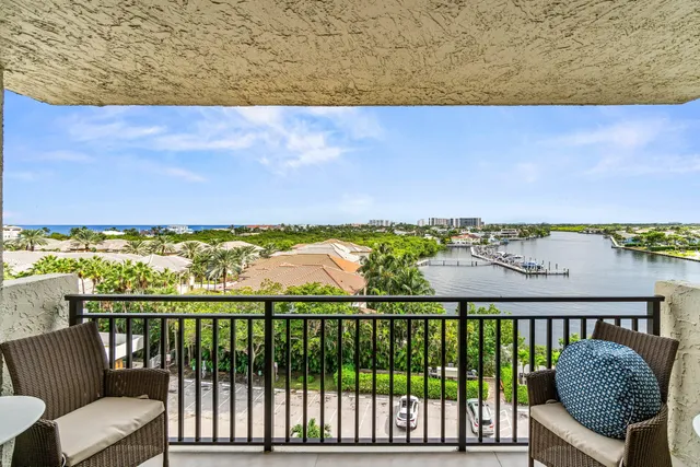 a balcony with wooden floor and city view