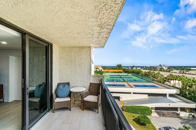 a view of a yard with an ocean and trees