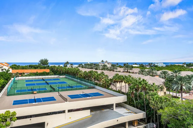 a living room with furniture couches and a dining table with garden view