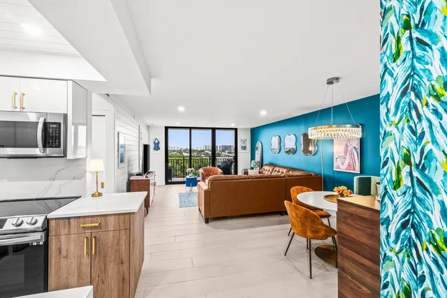 a living room with furniture a flat screen tv and a potted plant