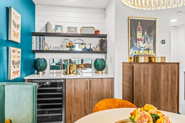 a view of a dining room with furniture a livingroom and chandelier
