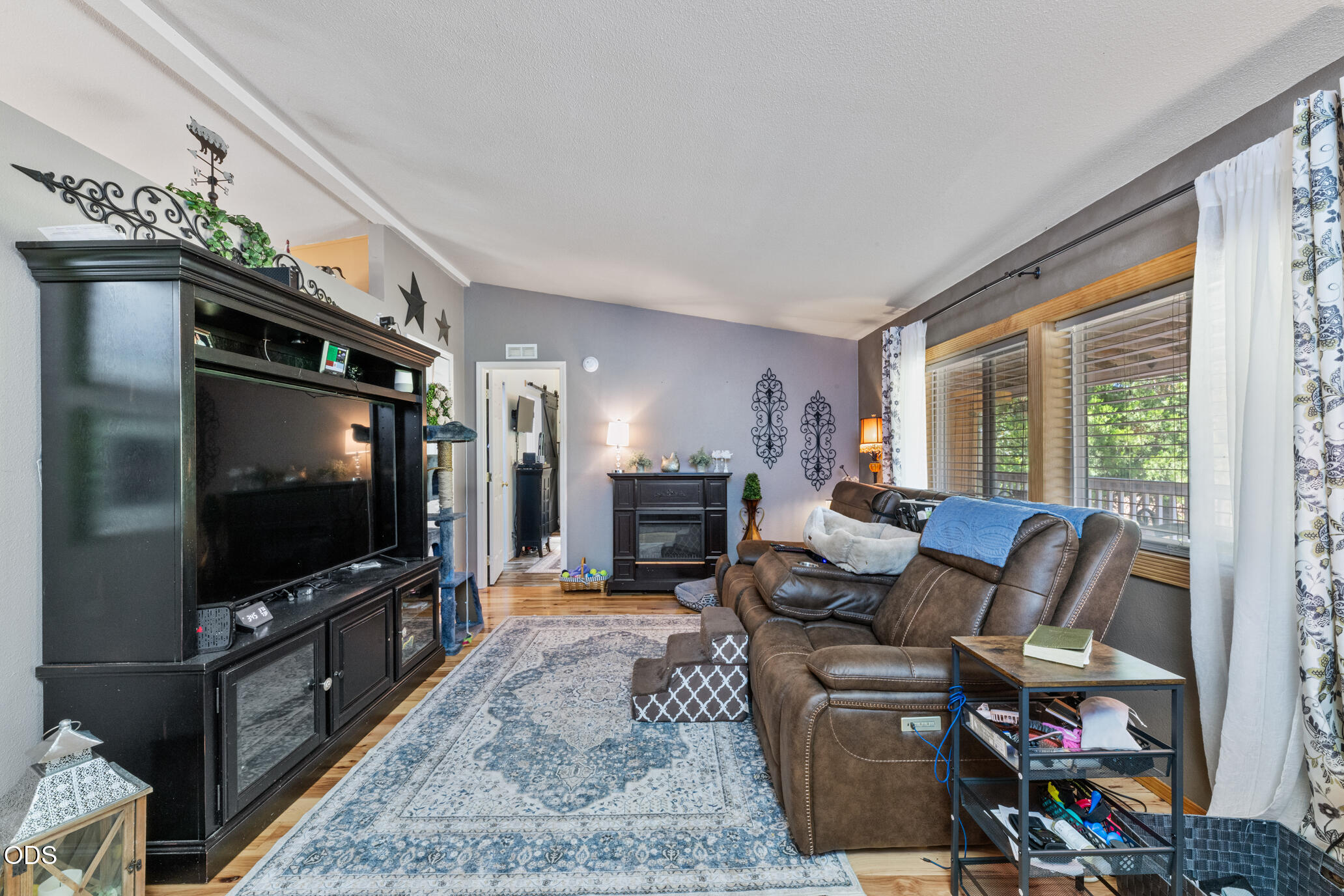 690 Foots Creek Road Gold Hill, OR 97525 - Photo 8 of 45 a living room with furniture and a flat screen tv