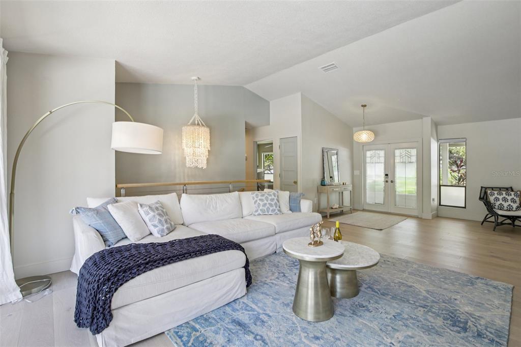 3390 Bayou Sound Longboat Key, FL 34228 - Photo 4 of 59 a living room with furniture and a wooden floor