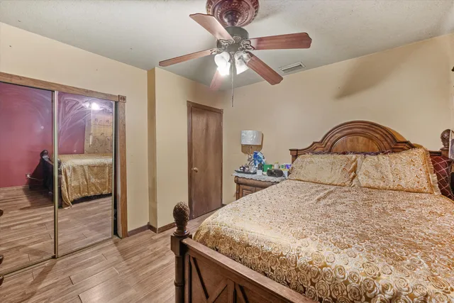 a bedroom with a bed and a chandelier