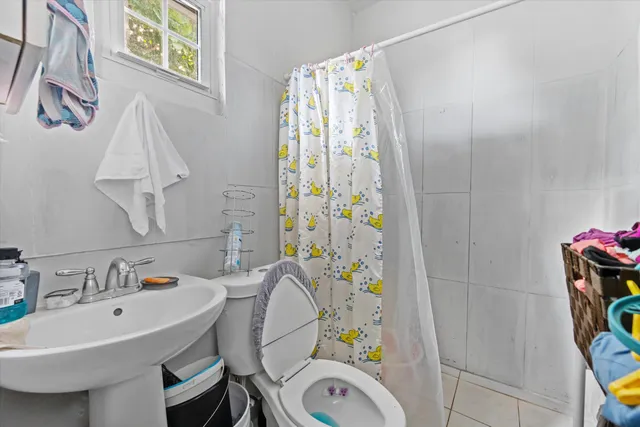 a bathroom with a sink mirror vanity and toilet