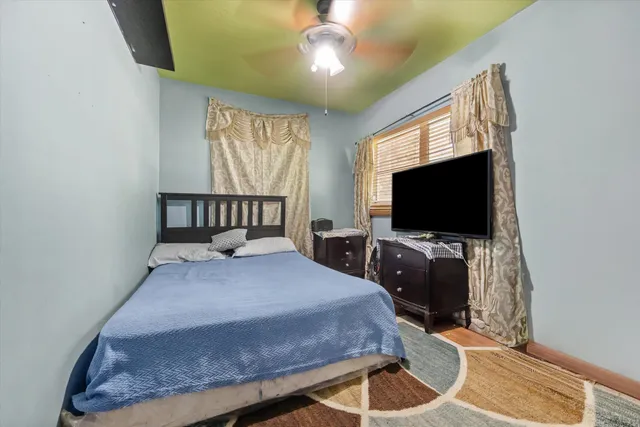 a bedroom with a bed and a flat screen tv