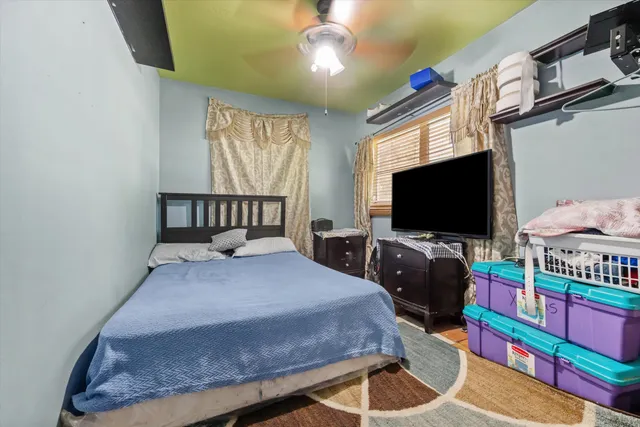 a bedroom with a bed and flat screen tv