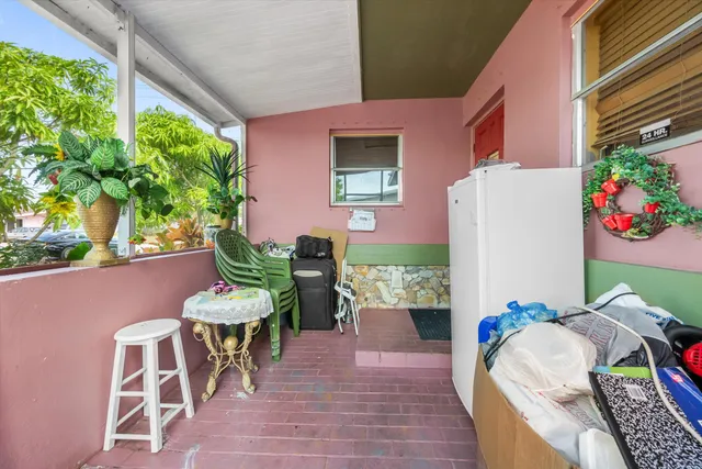 a front view of a house with outdoor seating