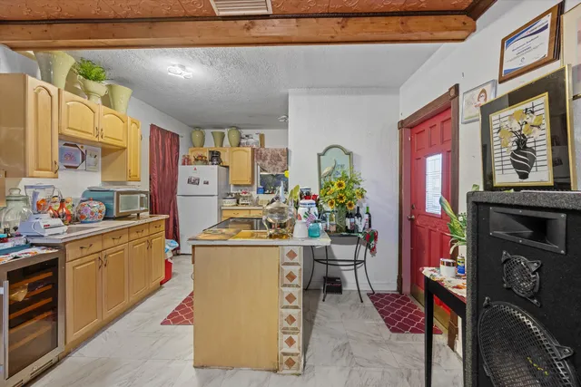 a kitchen that has a lot of cabinets stainless steel appliances and a counter top space