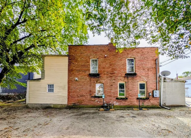 front view of a house with a tree
