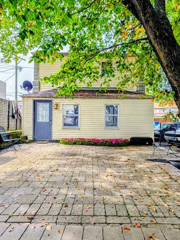 a backyard of a house with lots of green space and parking space