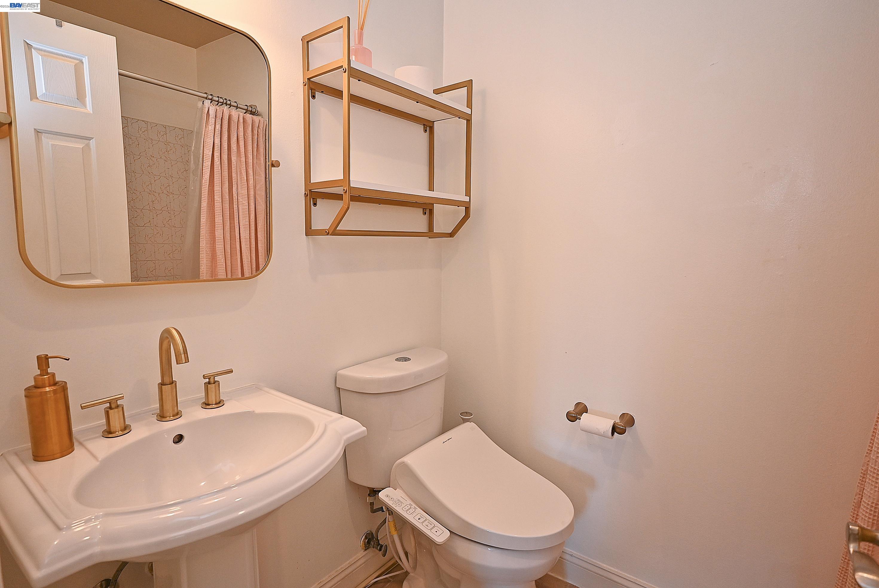 960 Shorepoint Court, Unit 215 Alameda, CA 94501 - Photo 11 of 22 a bathroom with a toilet sink and mirror