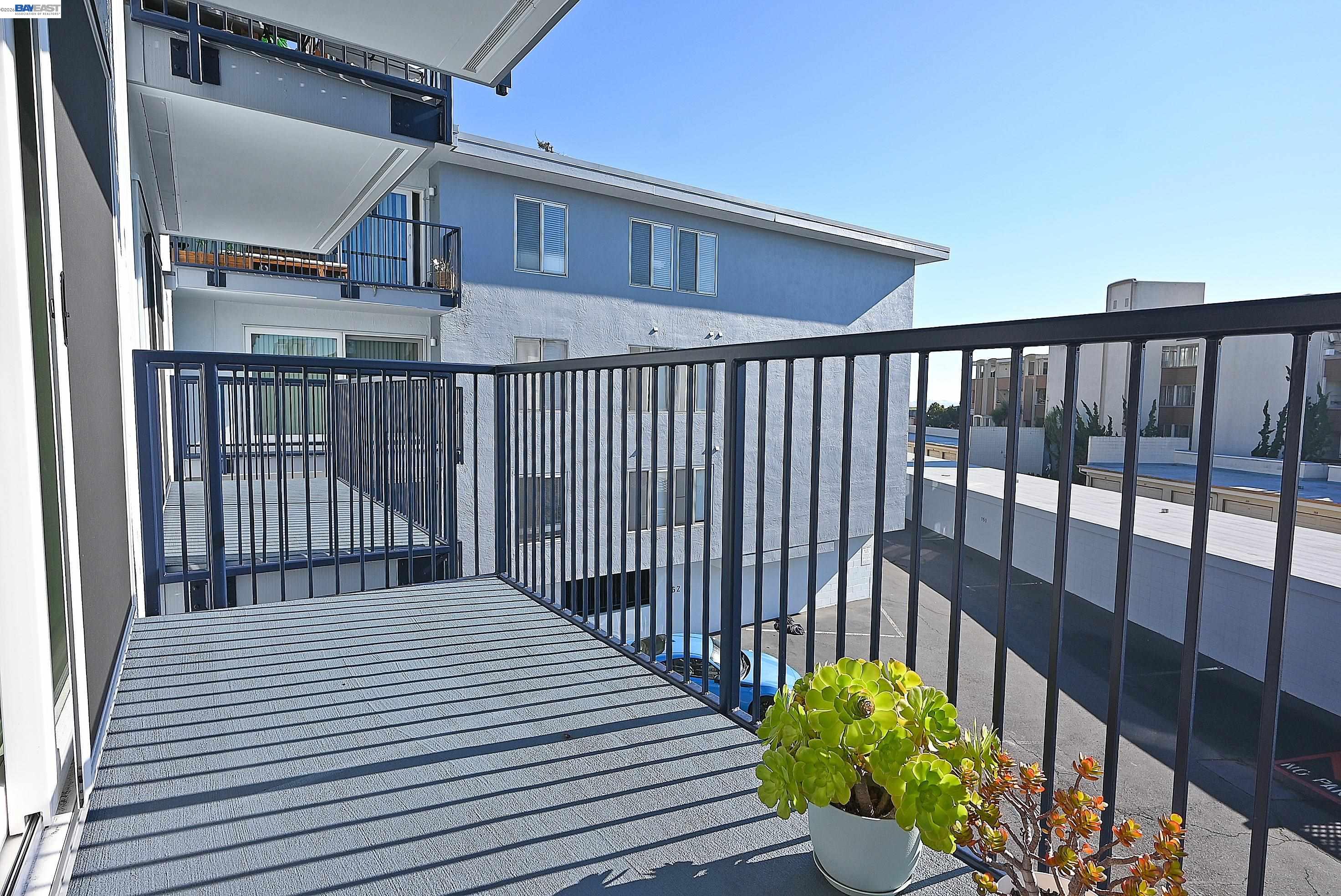 960 Shorepoint Court, Unit 215 Alameda, CA 94501 - Photo 15 of 22 a view of a balcony with wooden floor