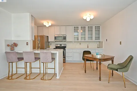 a kitchen with cabinets and chairs