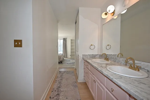 a bathroom with a sink double vanity and a mirror