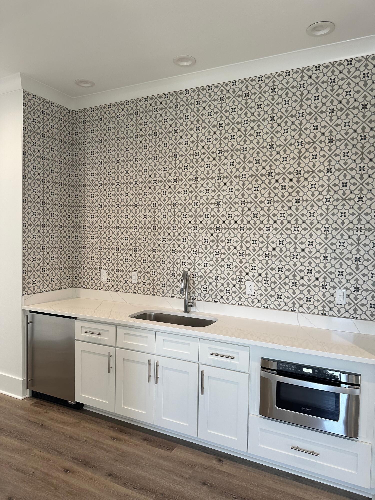 141 Maple Street Santa Rosa Beach, FL 32459 - Photo 11 of 11 a kitchen with a sink and a stove with wooden floor