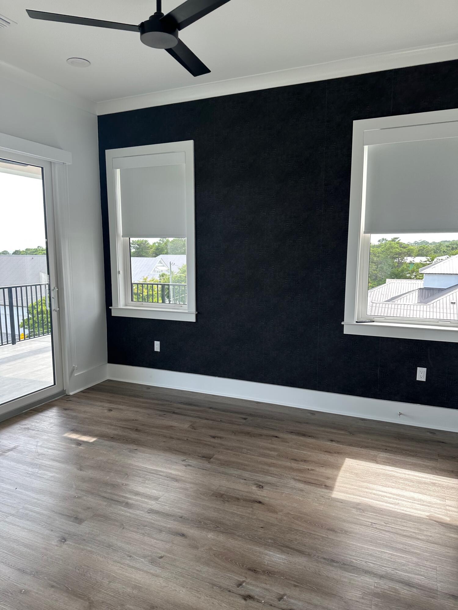 141 Maple Street Santa Rosa Beach, FL 32459 - Photo 8 of 11 a view of an empty room with wooden floor and a window