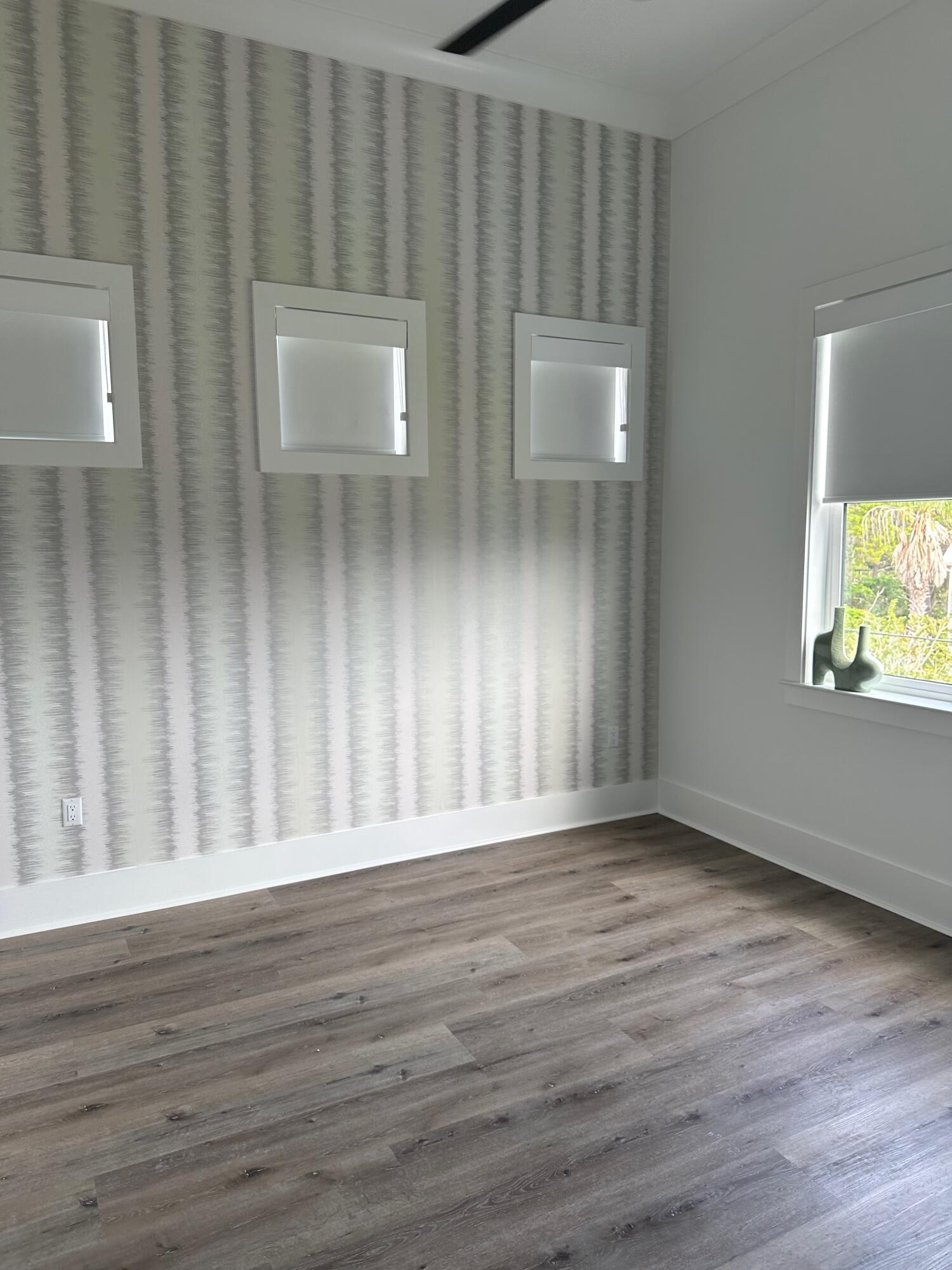 141 Maple Street Santa Rosa Beach, FL 32459 - Photo 10 of 11 a view of an empty room with wooden floor and a window