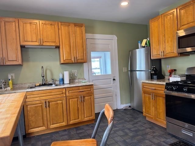 43 Sydney Street, Unit 2 Boston, MA 02125 - Photo 11 of 28 a kitchen with stainless steel appliances granite countertop a refrigerator a stove top oven a sink and dishwasher with wooden floor