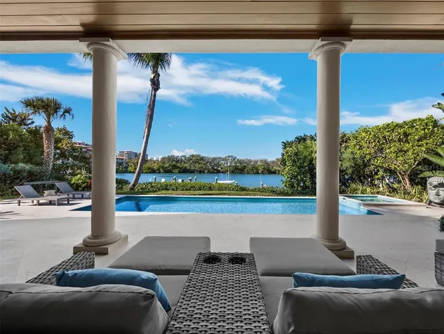 a spacious bedroom with a bed couch and window