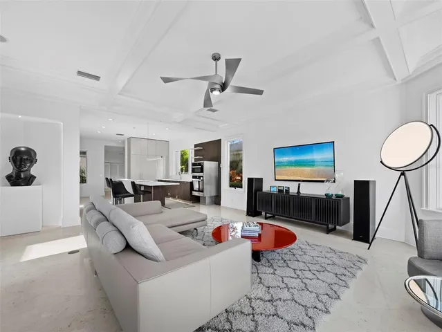 a living room with furniture a window and a flat screen tv