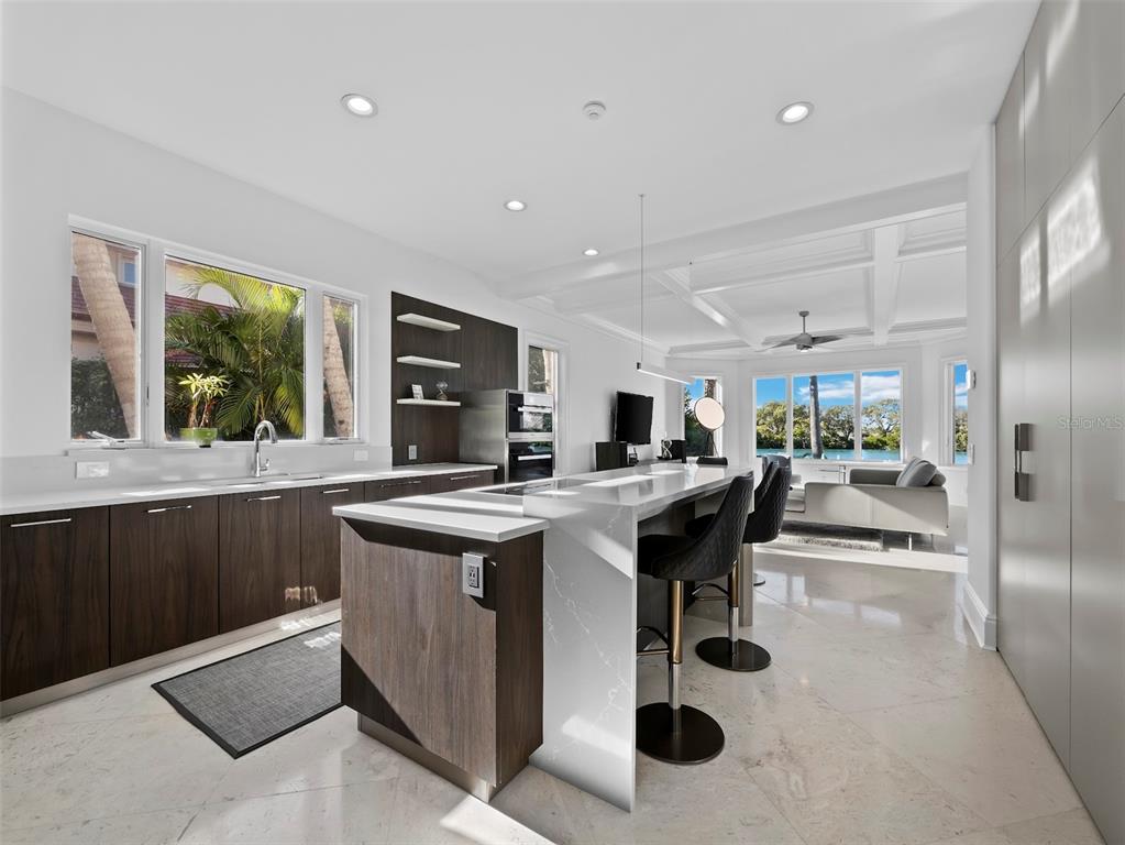 65 Lighthouse Point Drive Longboat Key, FL 34228 - Photo 21 of 90 a kitchen with a sink and view of living room