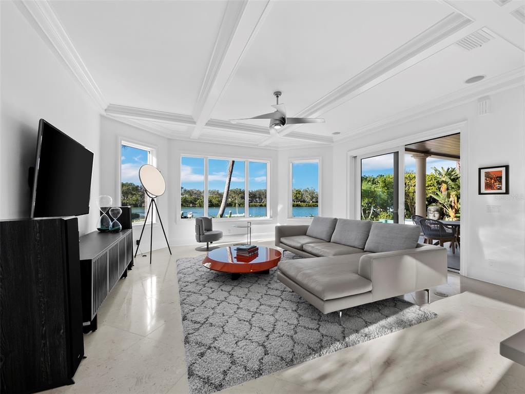 65 Lighthouse Point Drive Longboat Key, FL 34228 - Photo 22 of 90 a living room with furniture and a flat screen tv