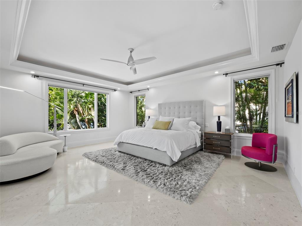 65 Lighthouse Point Drive Longboat Key, FL 34228 - Photo 25 of 90 a spacious bedroom with a bed couch and window