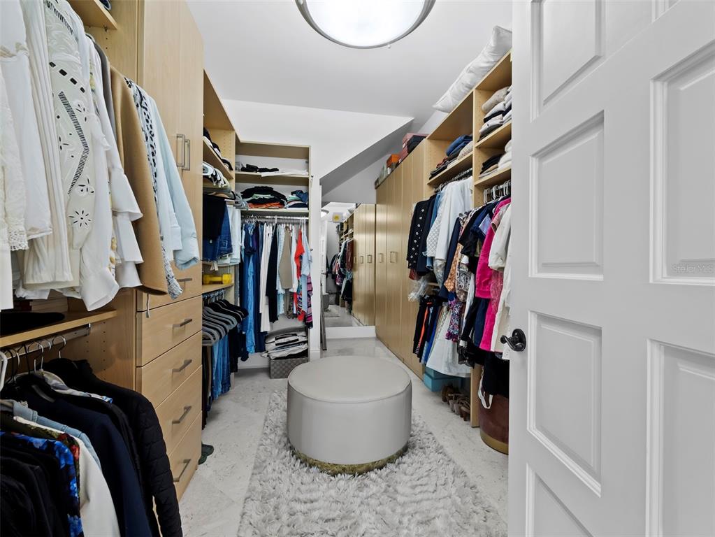65 Lighthouse Point Drive Longboat Key, FL 34228 - Photo 29 of 90 a view of walk in closet with clothes and shoes