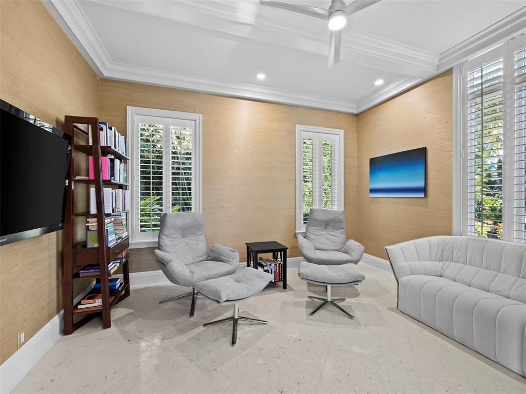 65 Lighthouse Point Drive Longboat Key, FL 34228 - Photo 34 of 90 a living room with furniture a window and a flat screen tv