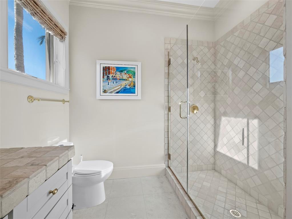 65 Lighthouse Point Drive Longboat Key, FL 34228 - Photo 41 of 90 a bathroom with a granite countertop sink a toilet and shower