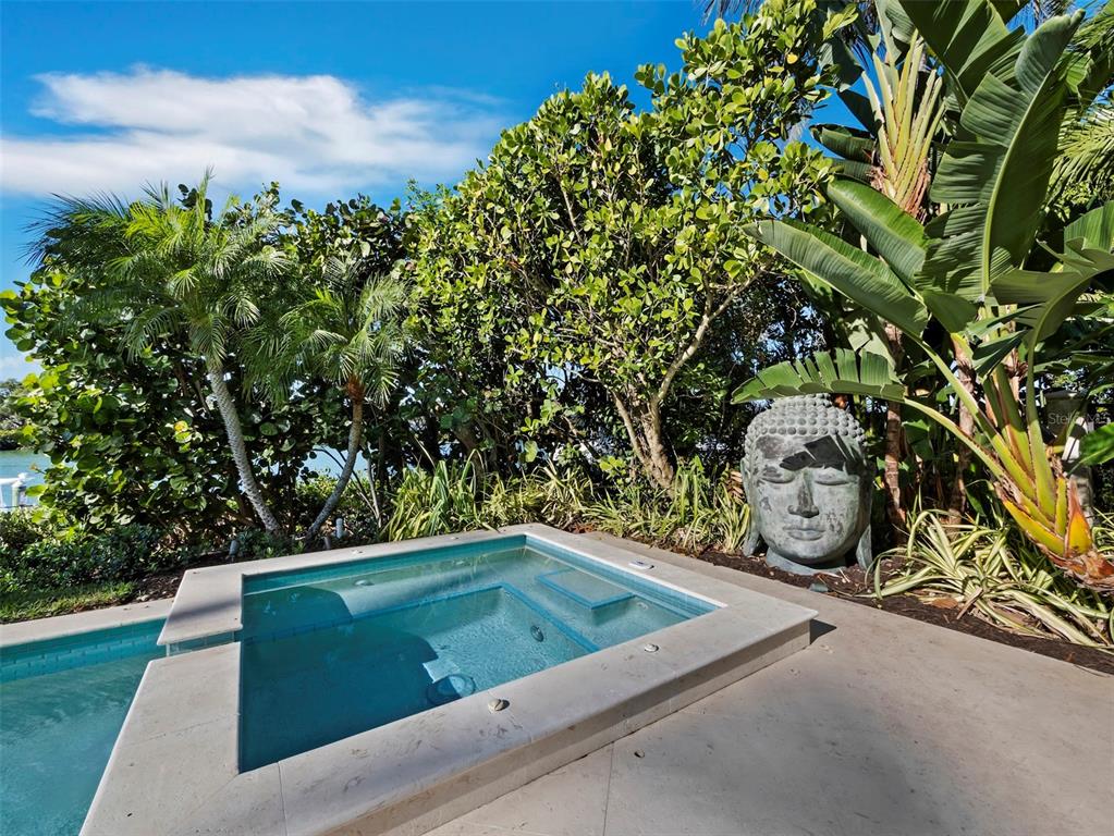 65 Lighthouse Point Drive Longboat Key, FL 34228 - Photo 60 of 90 a view of a backyard with sitting area