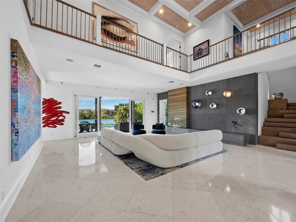 65 Lighthouse Point Drive Longboat Key, FL 34228 - Photo 8 of 90 a living room with furniture and a large window
