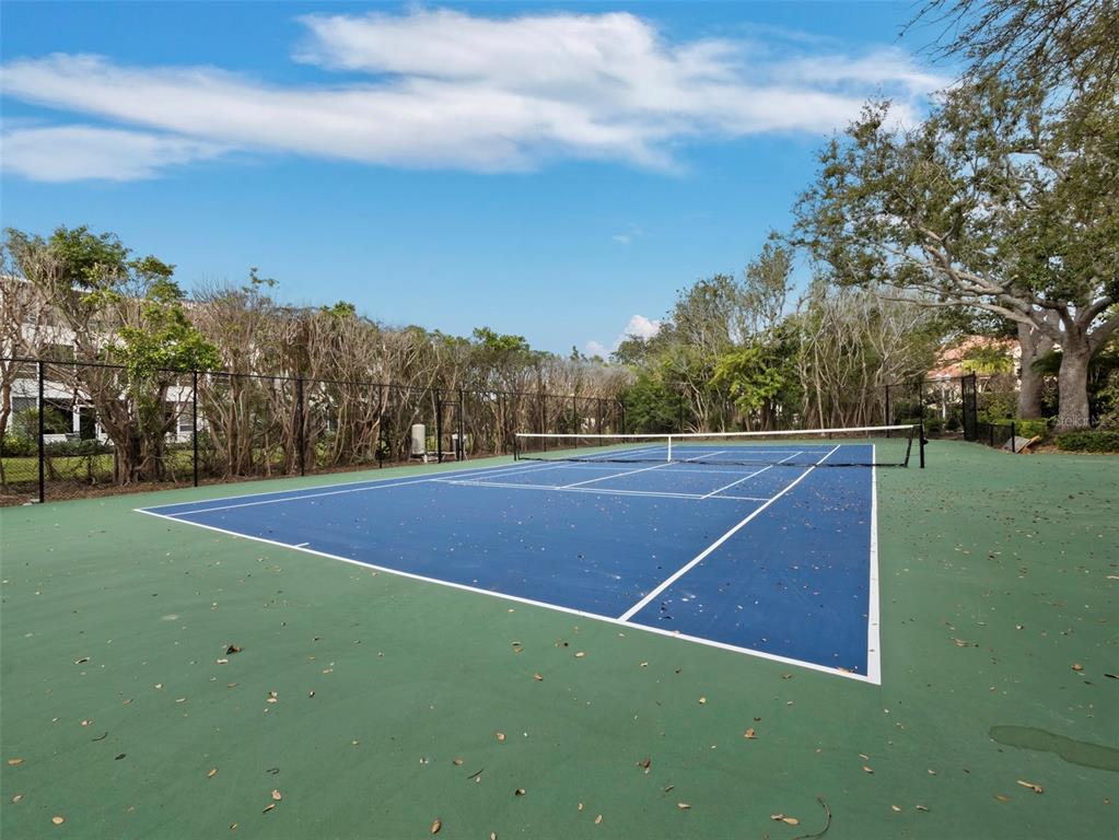 65 Lighthouse Point Drive Longboat Key, FL 34228 - Photo 85 of 90 a view of an outdoor space and tennis court