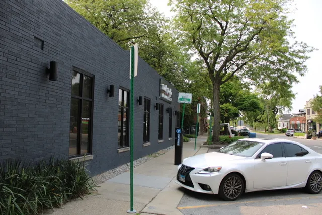 a car parked in front of a brick house