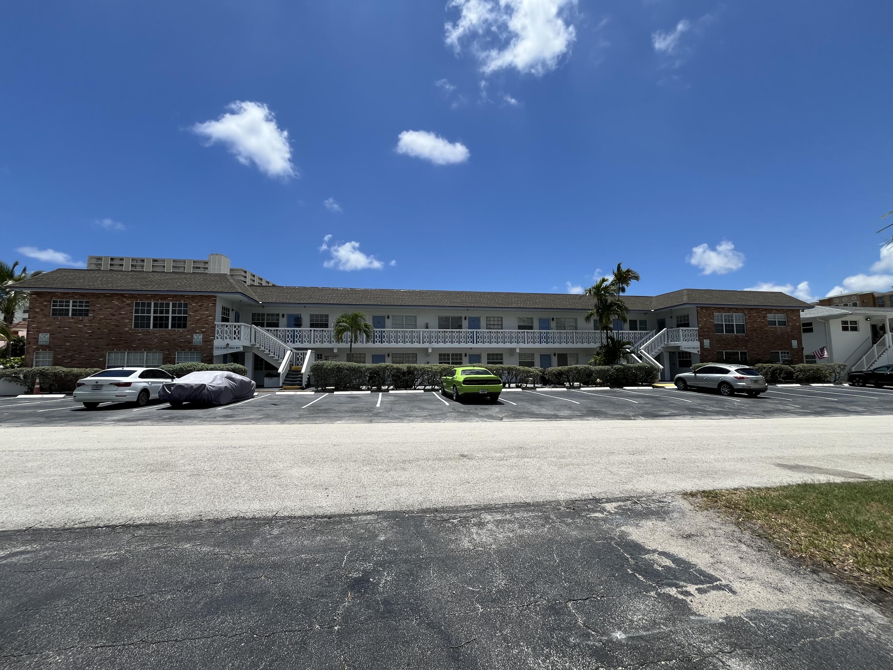 3220 Northeast 10th Street, Unit 4 Pompano Beach, FL 33062 - Photo 1 of 20 a view of street with parked cars