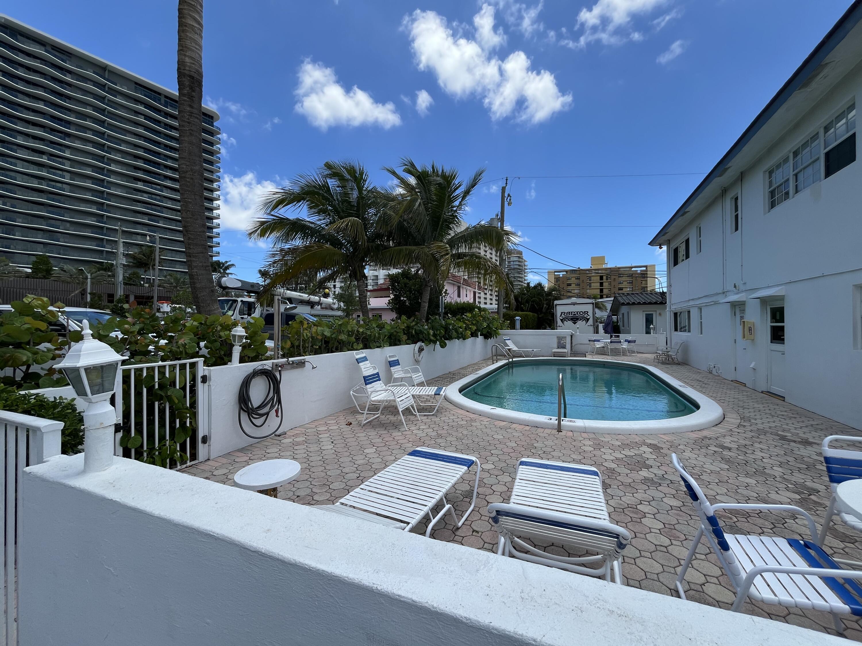 3220 Northeast 10th Street, Unit 4 Pompano Beach, FL 33062 - Photo 19 of 20 a view of a house with backyard and sitting area
