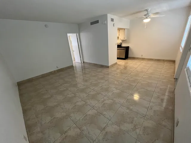 a view of a kitchen with a sink and a refrigerator