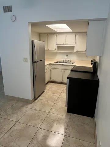 a kitchen with a sink a stove and a refrigerator