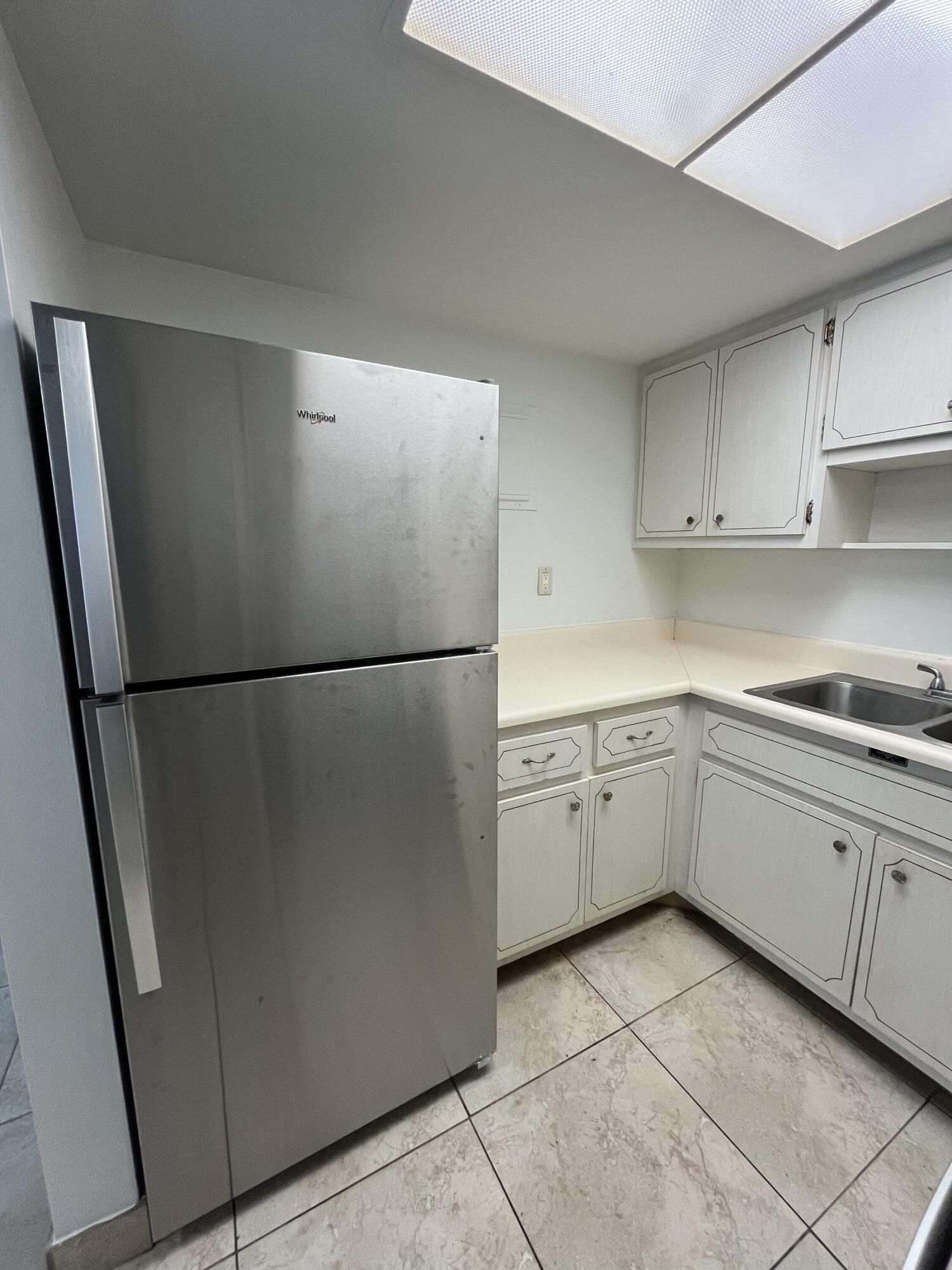 3220 Northeast 10th Street, Unit 4 Pompano Beach, FL 33062 - Photo 7 of 20 a kitchen with cabinets and refrigerator