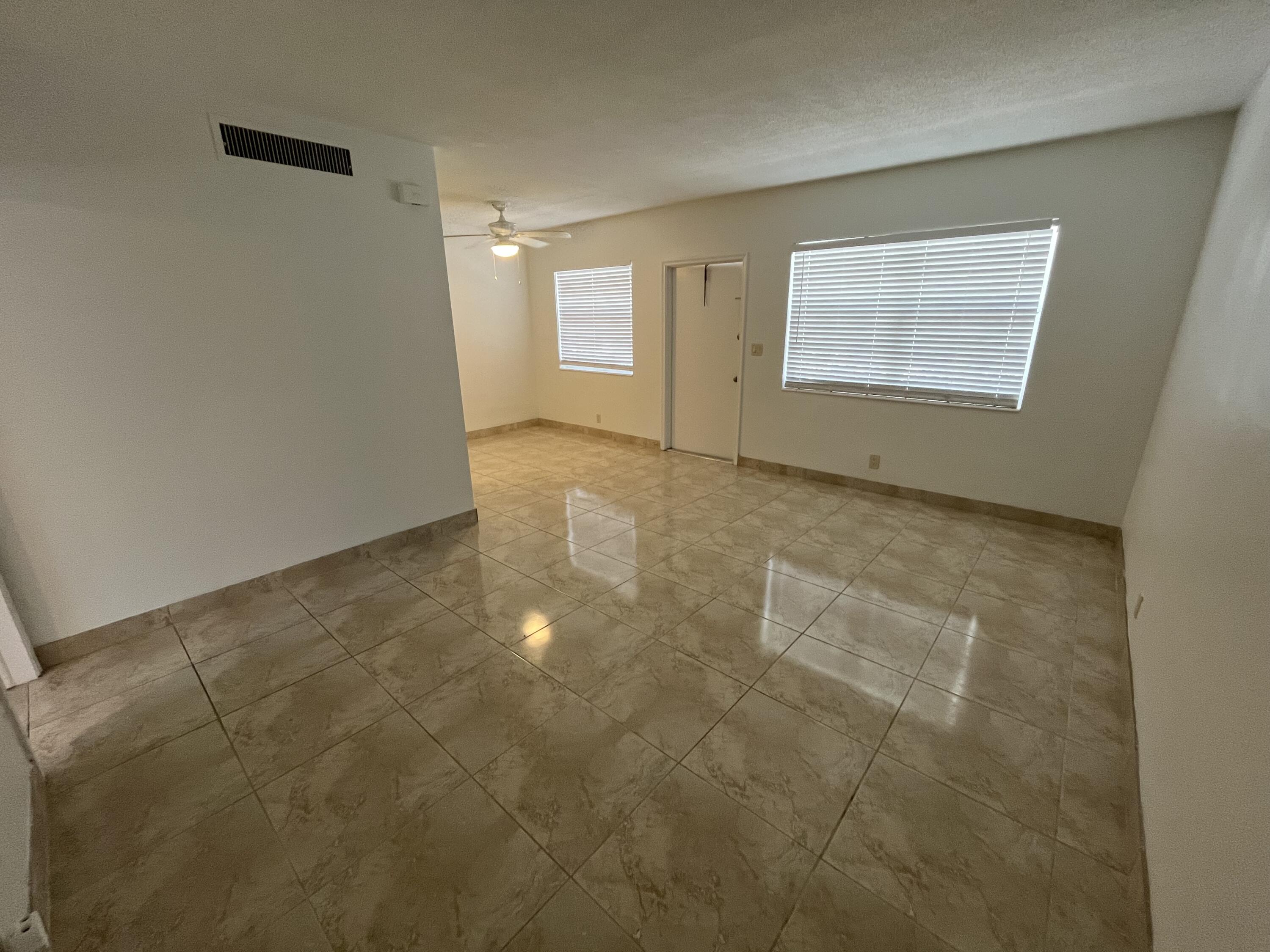 3220 Northeast 10th Street, Unit 4 Pompano Beach, FL 33062 - Photo 10 of 20 a view of an empty room with a window