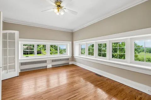 a view of room with window and wooden floor