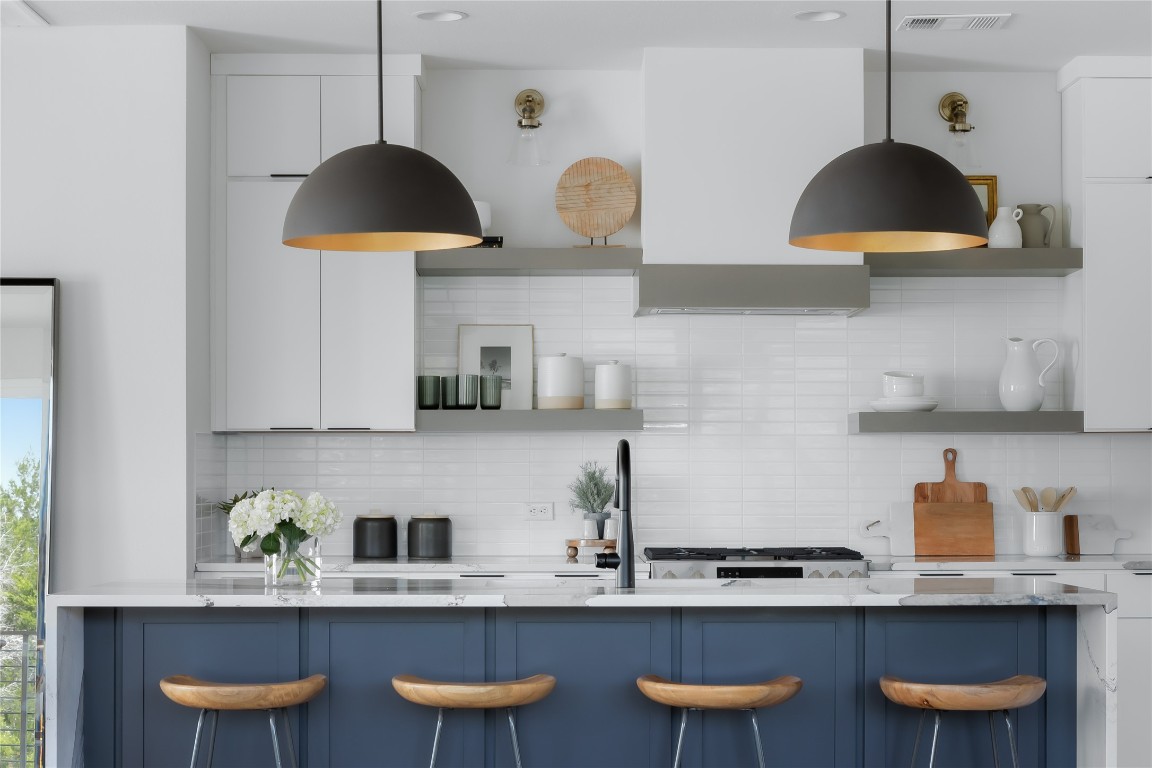 7809 Old Bee Caves Road, Unit 15 Austin, TX 78735 - Photo 11 of 26 a kitchen with stainless steel appliances granite countertop a sink a stove and a wooden floors